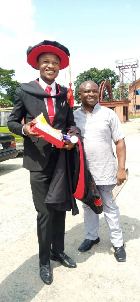 The Managing Director of ISUN Multipurpose Cooperative Society displaying his Doctorate Award at Evangel University.