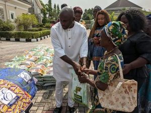 Chief Amobi Ogah distributing gift items to his Constituents.