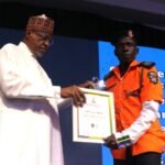 Honourable Minister of Police Affairs, Senator Ibrahim Gaidam, decorating INSPR Alabi Kayode, Kwara State Command (3rd recipient of the Traffic Warden of the Year) during the Nigeria Police Awards and Commendation 2nd award ceremony held at the Police Resource Centre Jabi, Abuja.