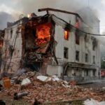 Firefighters work at the site of a building hit by a Russian drone attack in Kharkiv, Ukraine, on June 7, 2025
