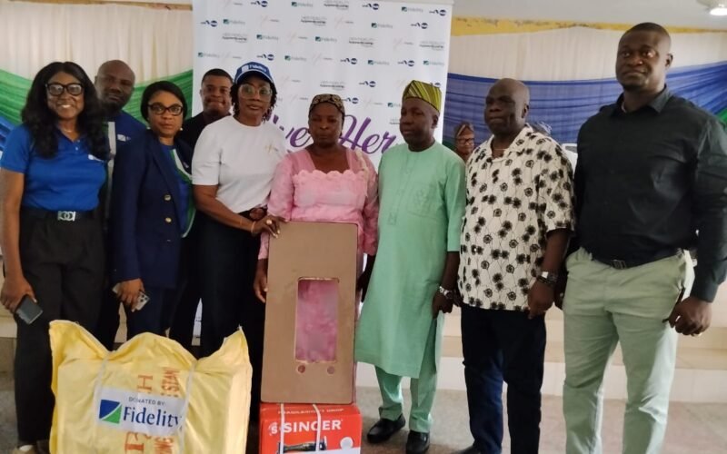 Photo caption: L-R: Team Lead, CSR, Fidelity Bank Plc, Victoria Abuka; Retail Team Rep., Fidelity Bank Plc, Stanley Ogbuze; Branch Leader, Fidelity Bank Plc, Adeola Odeku Branch, Ifeyinwa Asomugha; Public Sector Team Rep., Nnaemeka Ike; Head, Women Banking, Fidelity Bank Plc, Harriba Harry-Pepple; a beneficiary, Mrs. Akinsanya Abeke; Executive Chairman, Imota LCDA, Hon. Benson Sunday Ayodele; Executive Chairman, Ikorodu West LCDA, Hon. Sulaimon Kazeem Olanrewaju; and Chairman, Ikorodu Local Government, Prince Adedayo Ladega, during the Fidelity Bank “Give Her Power Initiative” which held in Ikorodu, Lagos recently.